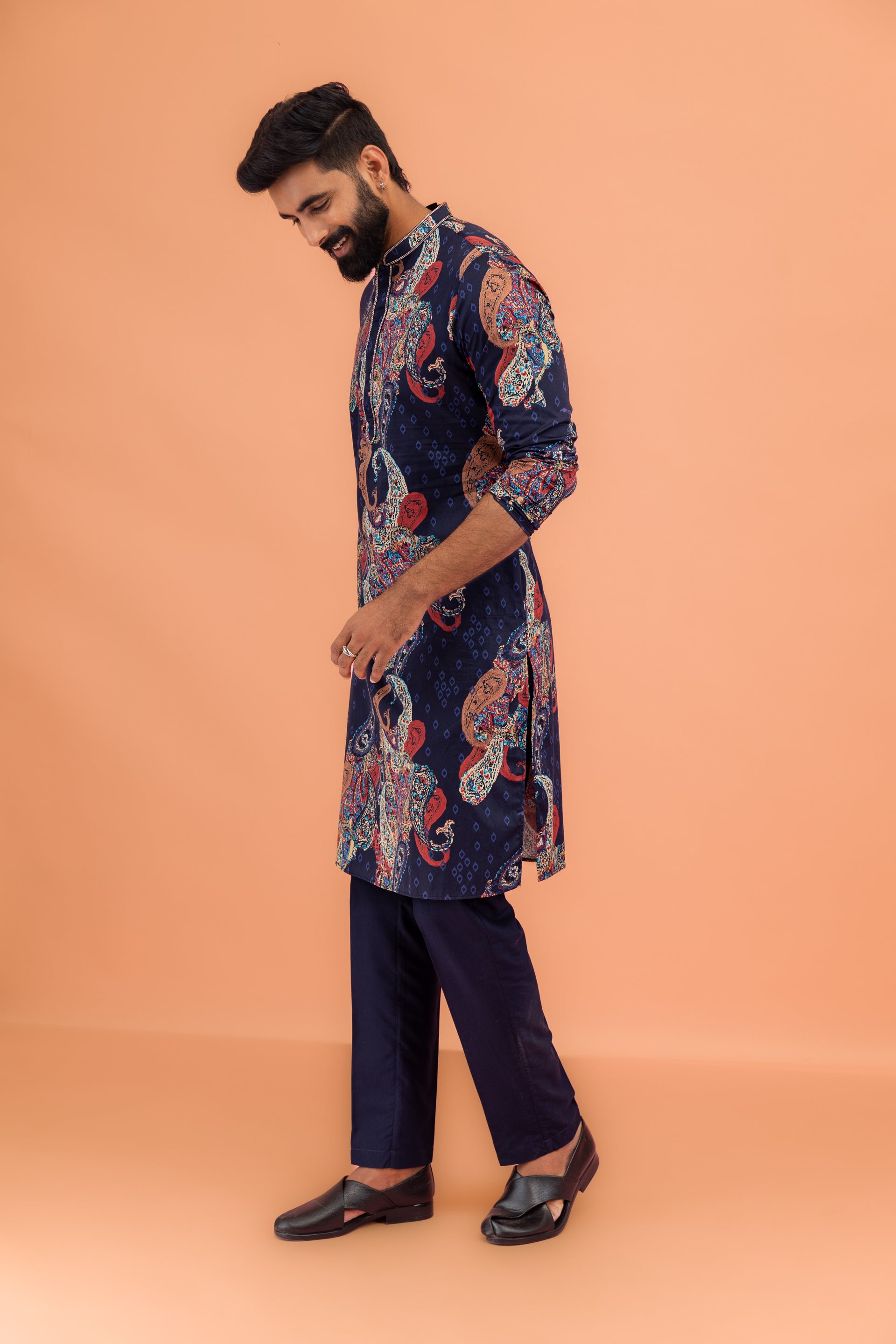 The model is seen from a side angle, wearing Kisah Men’s Navy Blue Kurta Trouser Set with a relaxed stance.