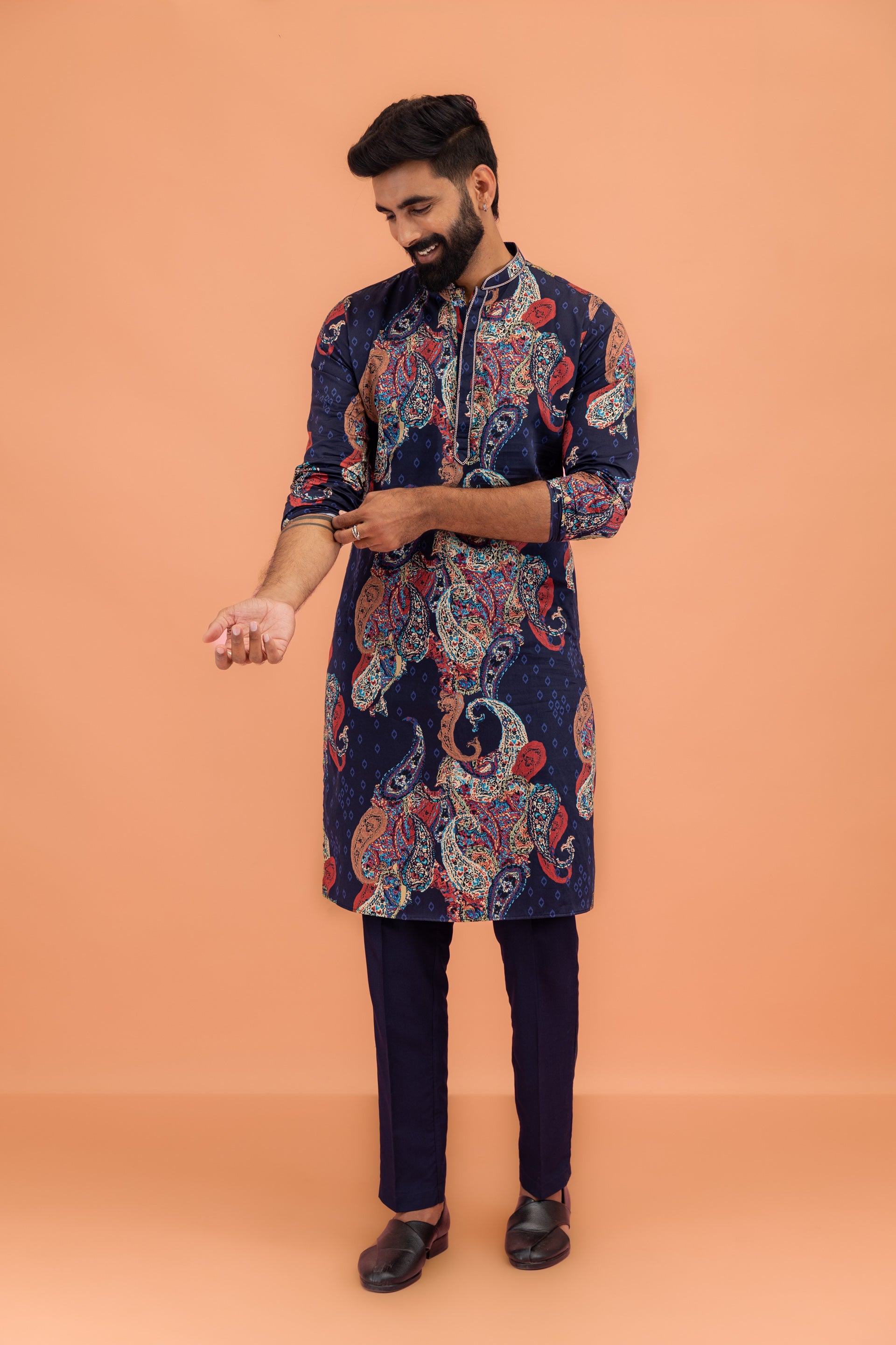 The model is in rolling up sleeve pose in his Kisah's kurta set.