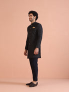 Shown here is the model in a side profile, wearing Kisahâ€™s navy blue embellished Indo-Western trouser set