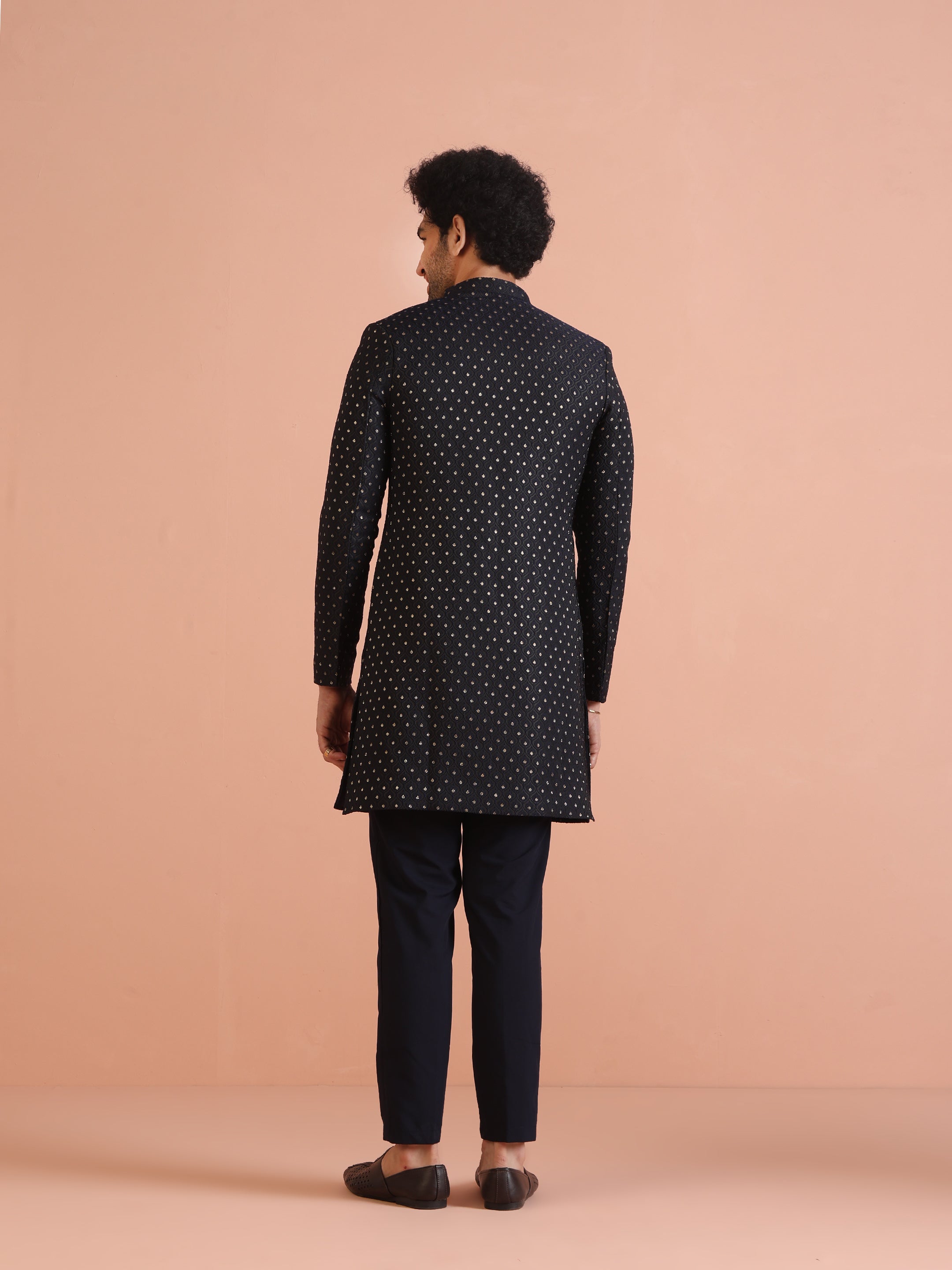 The back view of the model, wearing Kisah's  Navy Blue Embellished Indowestern Trouser Set 