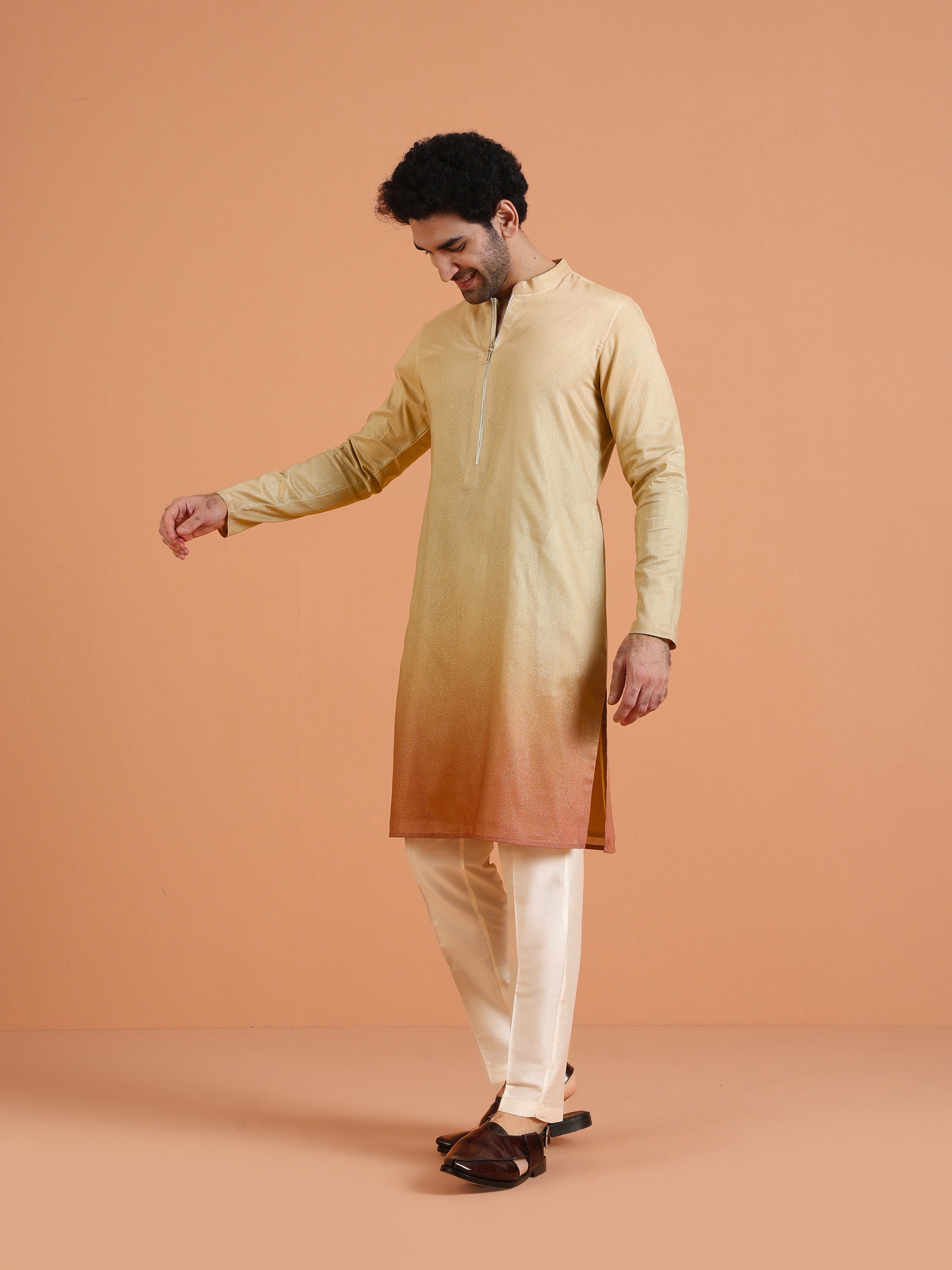 Standing tall in Kisah's Beige Ombre Kurta Zip Set, the model keeps his right hand up