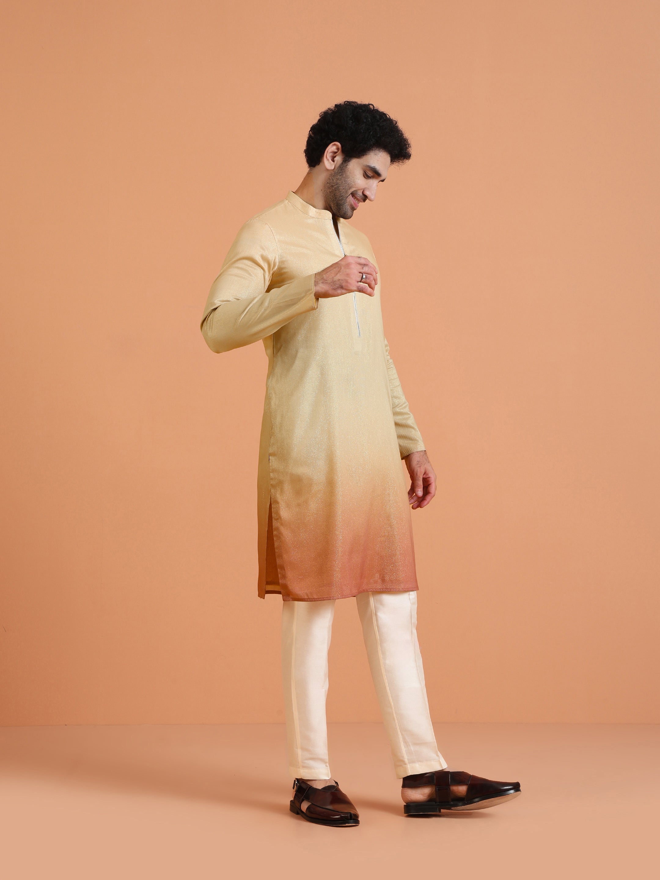 The model in Kisah's Beige Ombre Kurta Zip Set is standing with his right hand raised