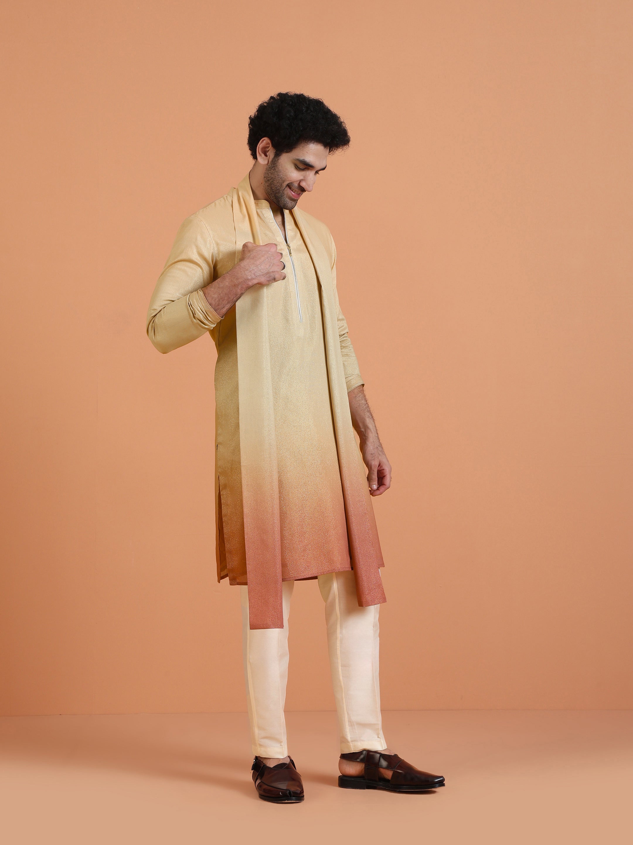 Wearing the Beige Ombre Kurta Zip Set with Dupatta, the model stands with his head lowered
