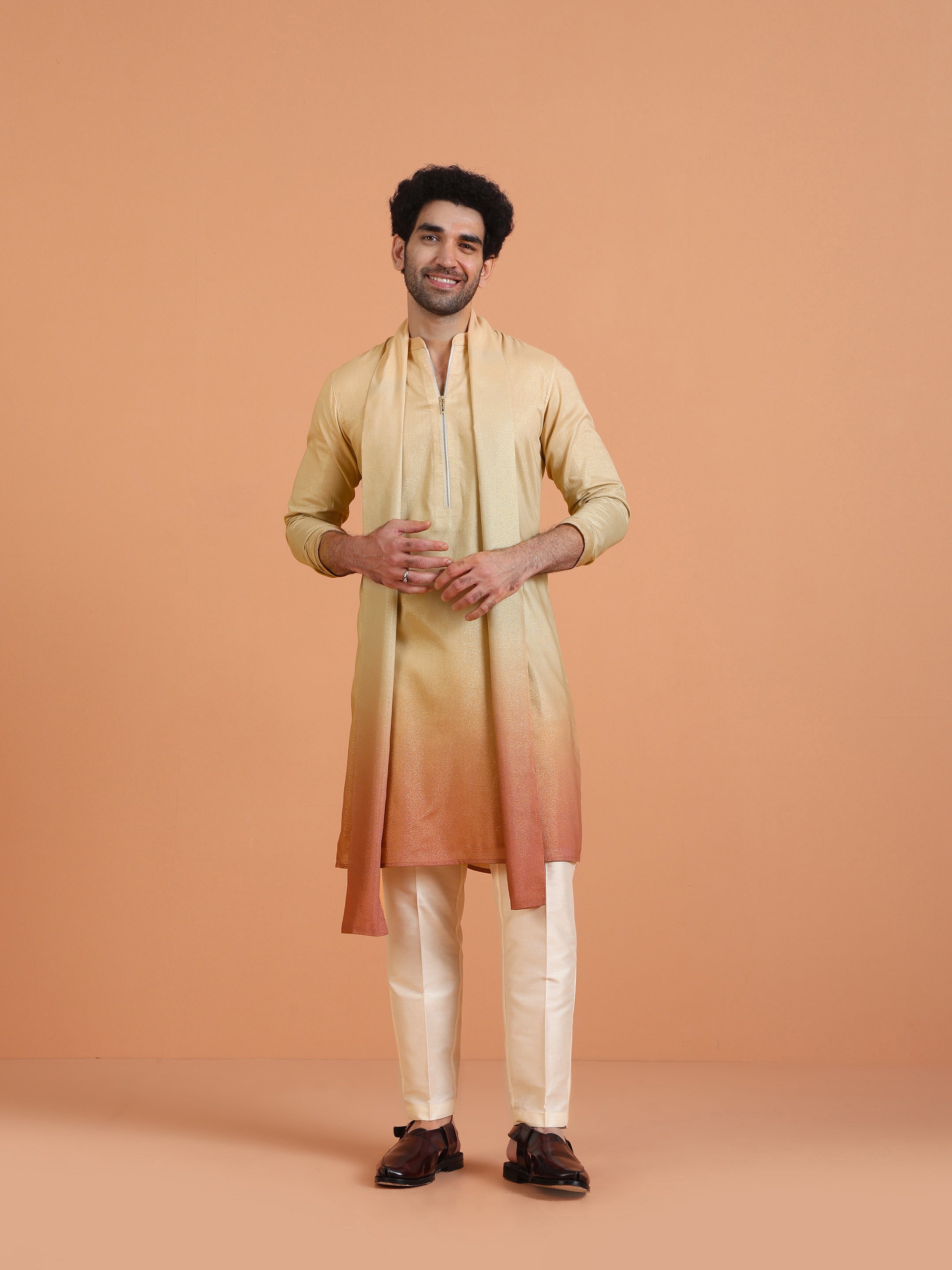 The model is standing casually, wearing  Kisah's  Beige Ombre Kurta Zip Set with Dupatta