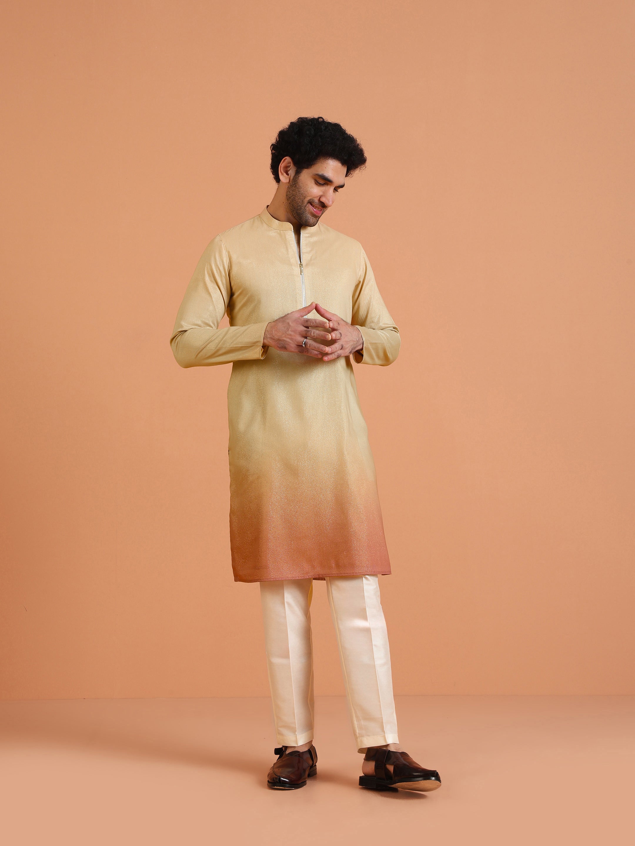 The man poses confidently in the Beige Ombre Kurta Zip Set from Kisah