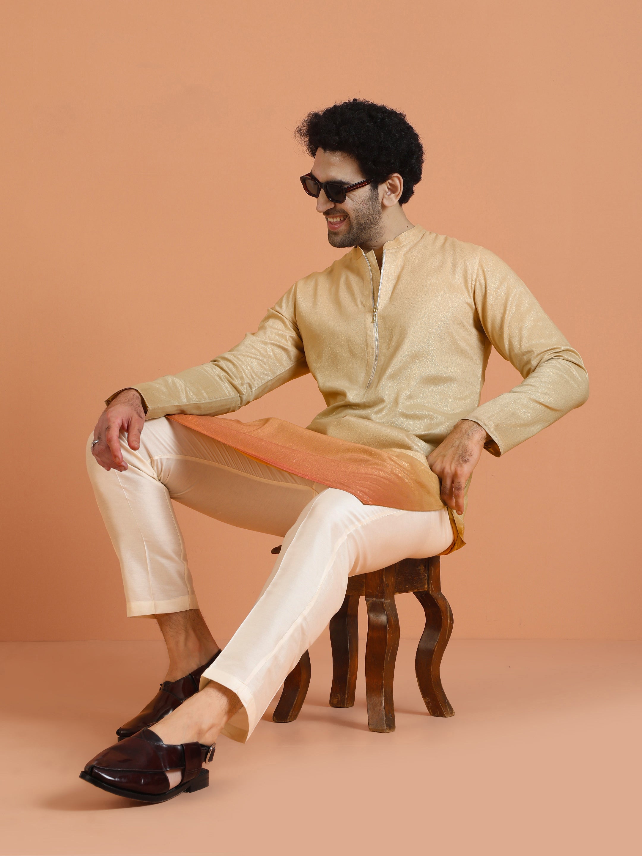 The man in sunglass is sitting, posing with Beige Ombre Kurta Zip Set of Kisah