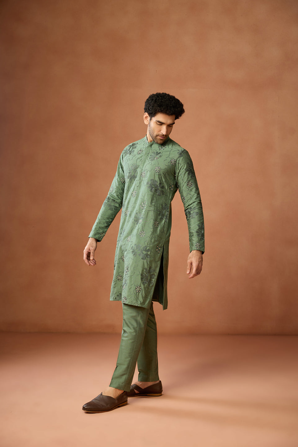Keeping his hand side, the man is posing with Kisah's Green Floral Embroidered Kurta Set