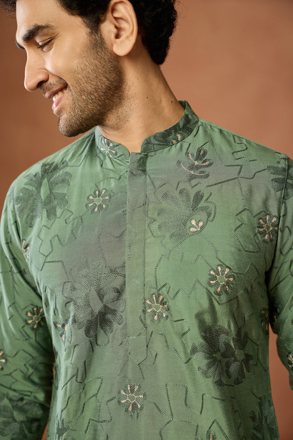 Green silk blend floral embroidered kurta on the chest has been focused in the image