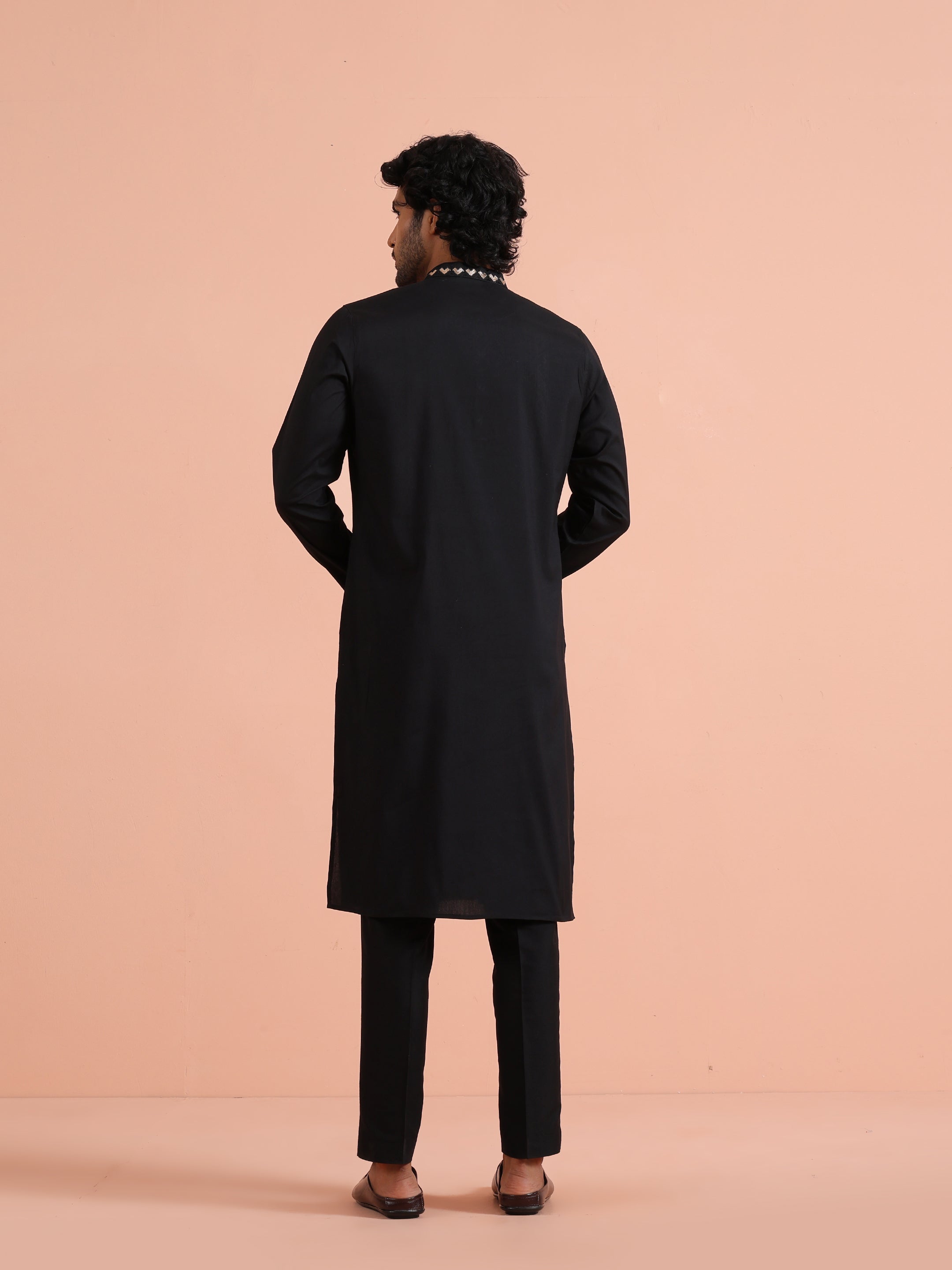 The back view of the model, wearing Kisah's  Black Metallic Embroidered Kurta Set